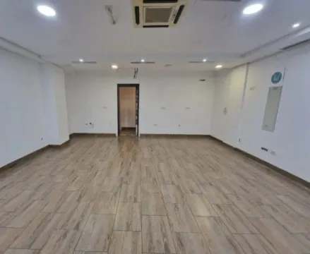 An empty, spacious room with light floor tiles. - image 4
