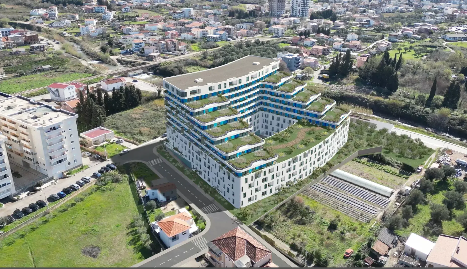 Vizuelni prikaz moderne stambene zgrade iz vazduha sa uređenim terasama i okruženjem.