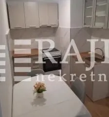 Small kitchen with a dining table and chairs.