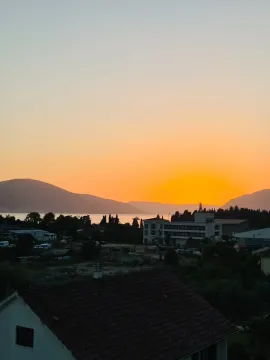 View of the sunset, sea and surrounding buildings from the terrace. - image 6