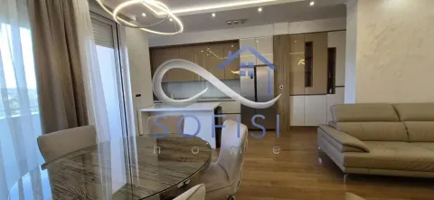 Spacious living room with a dining area and an integrated kitchen in the background. - image 16