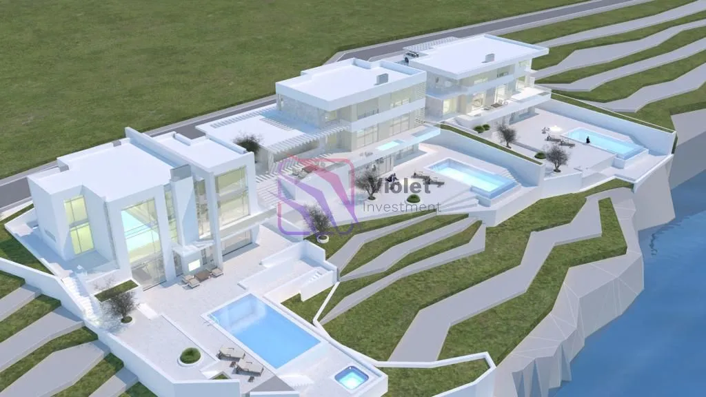 Pogled iz vazduha na kompleks modernih vila sa bazenima.