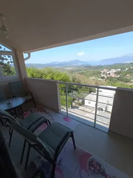 Covered balcony with seating furniture and nature view. - image 6