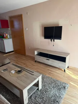 Living room with a TV unit and coffee table. - image 5
