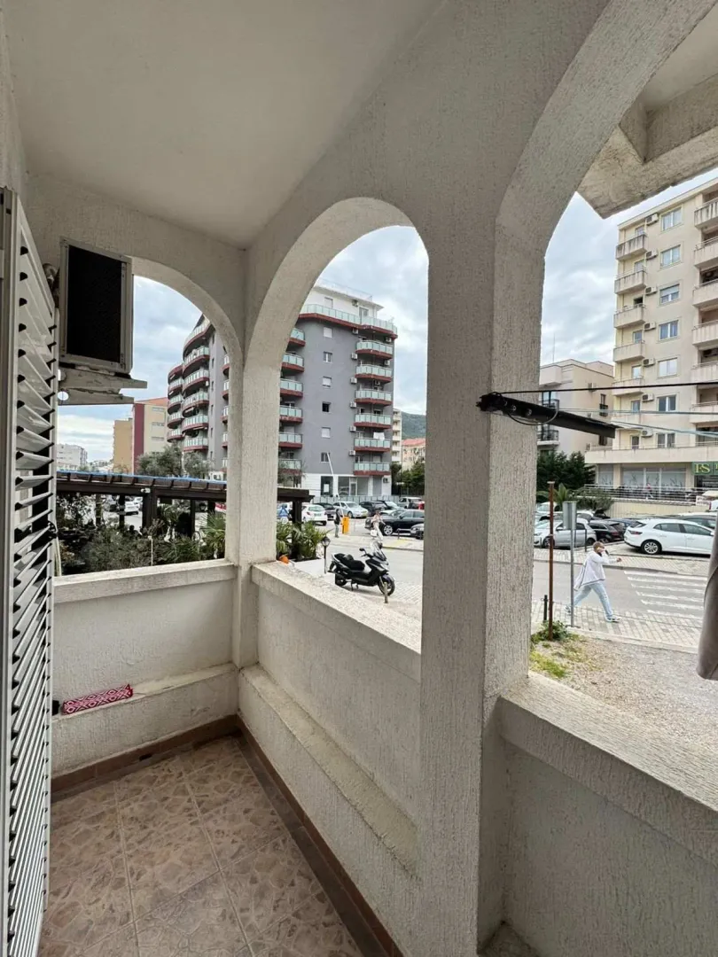 Covered balcony with a view of the street and surrounding buildings.