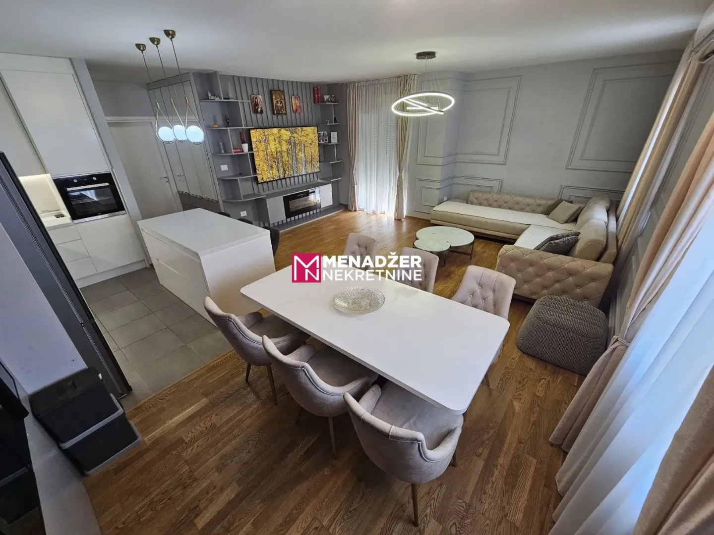 Modern living room with dining area and open-plan kitchen.