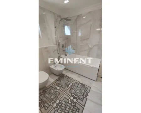 Modernly equipped bathroom with a bathtub, glass shower screen, and sanitary fixtures. - image 16