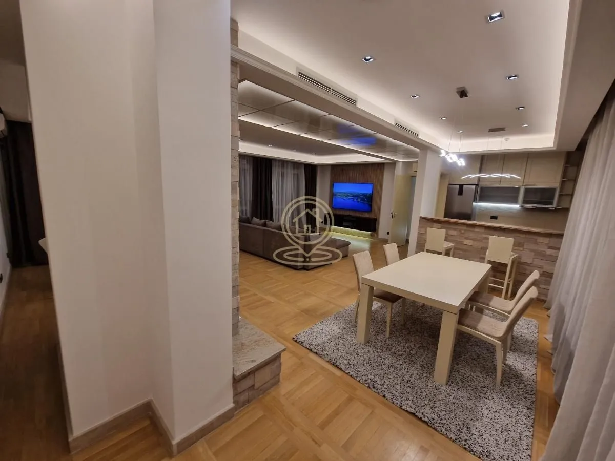 Living room with dining area and kitchen in the background.
