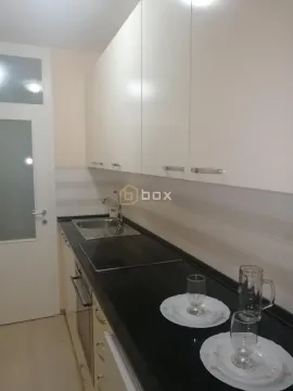 Small kitchen with white cabinets and black countertops. - image 7