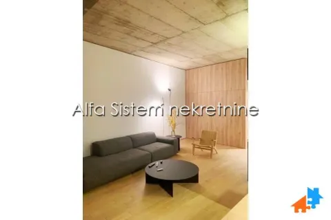 Living room with a sofa, coffee table and wooden wall panels. - image 4
