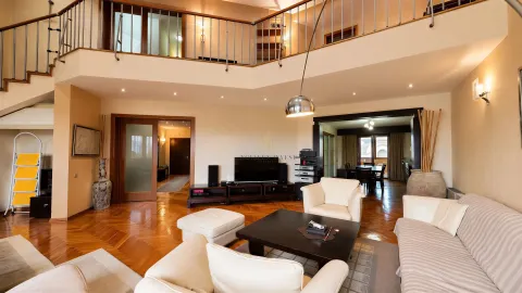 Spacious living room with a gallery and parquet flooring. - image 2