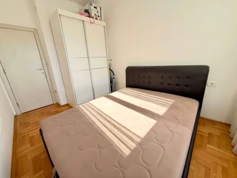 Bedroom with a double bed, wardrobe, and parquet flooring. - image 6