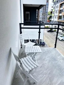 Furnished terrace with seating set and view of surrounding buildings. - image 7
