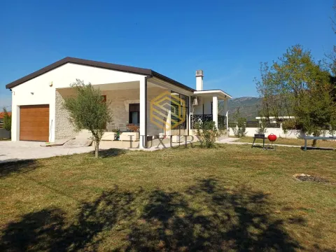 Exterior of a single-story house with a spacious yard and terrace. - image 4