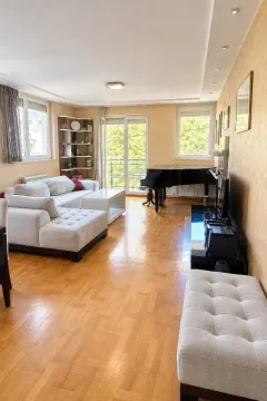 Spacious living room with a sofa set, piano, and access to the terrace. - image 2