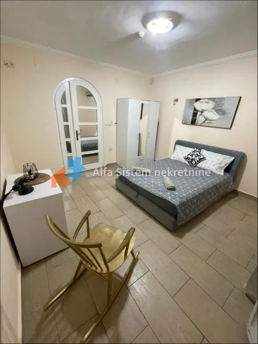 Furnished bedroom with a double bed, wardrobe, and a rocking chair.
