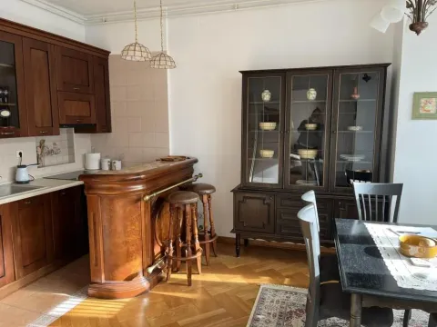 Dining area with a kitchen featuring wooden cabinetry and a bar counter. - image 5
