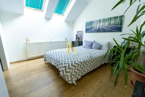 Attic bedroom with a double bed and skylights. - image 21