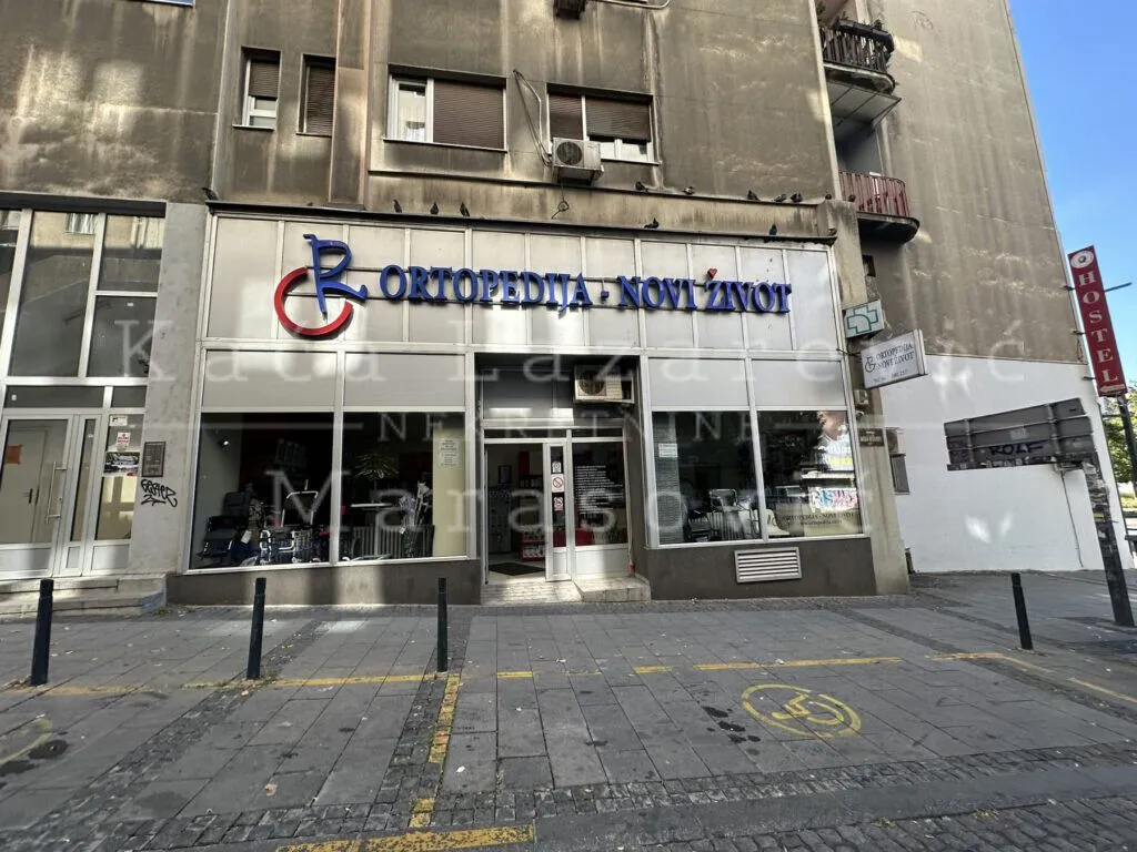 View of the exterior of the commercial space with a sign.