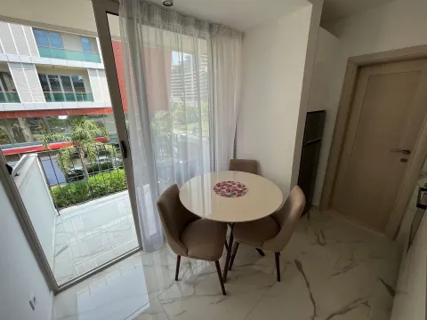 Dining area with a table and chairs next to the balcony doors. - image 5