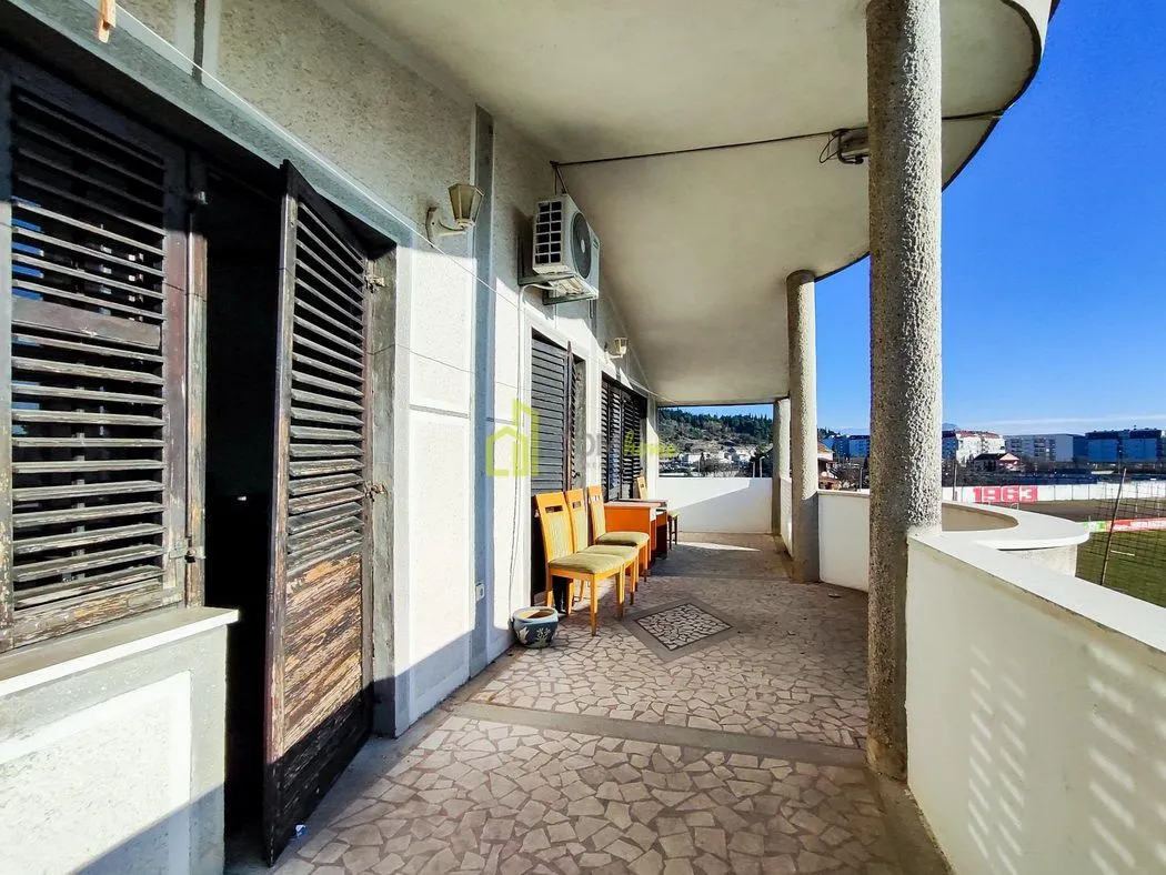Spacious covered balcony with a view of the surroundings.