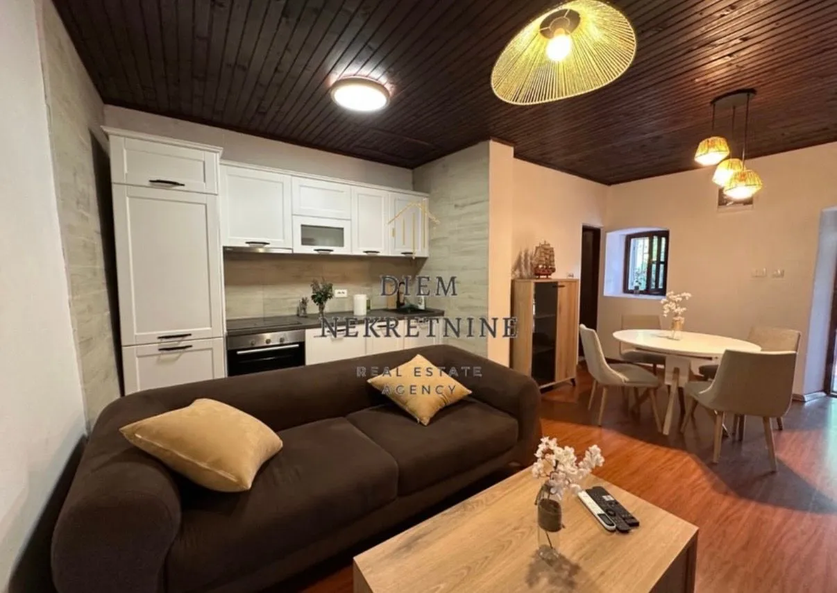 Open-plan living room with dining area and kitchen.