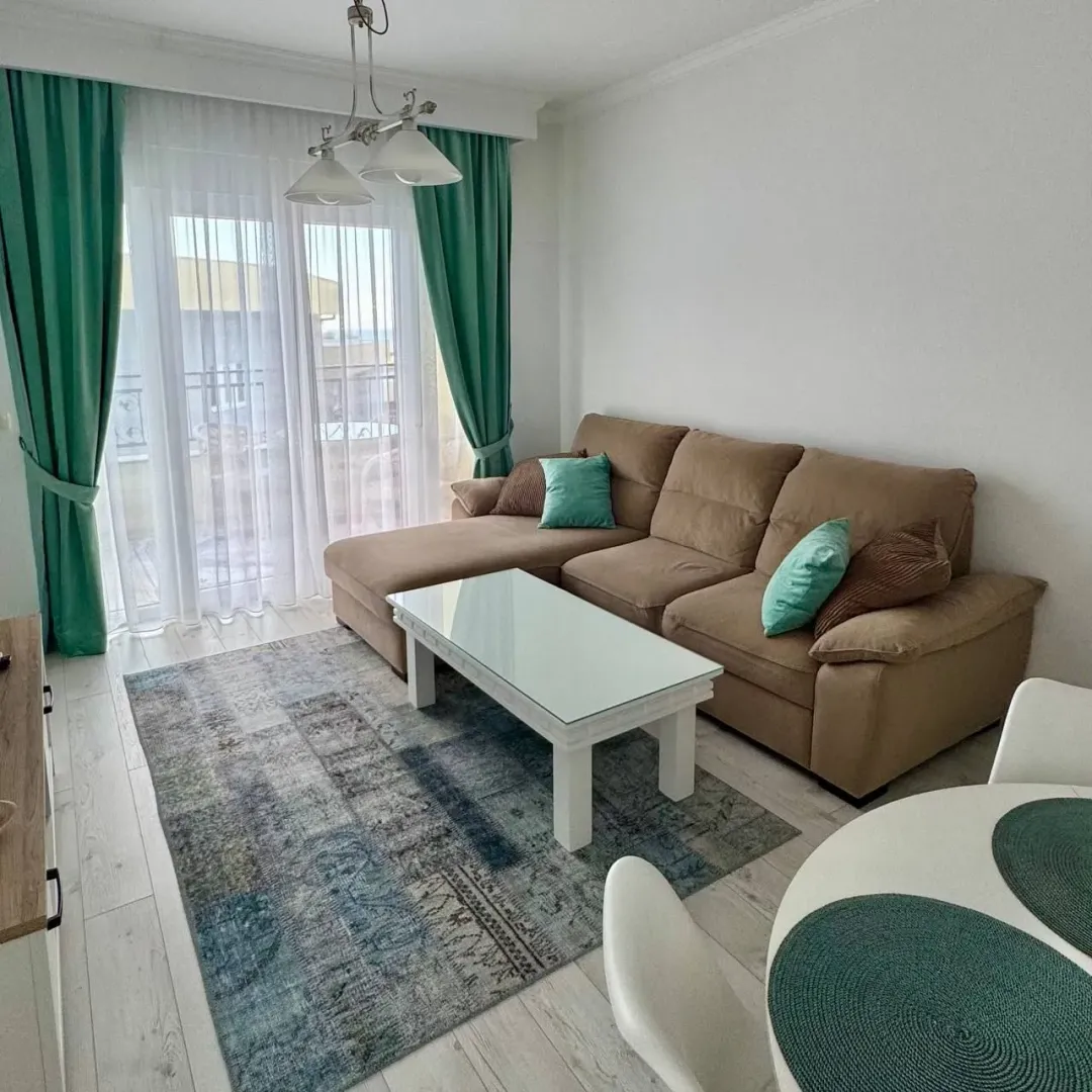 Living room with a sofa, coffee table, and access to the terrace.