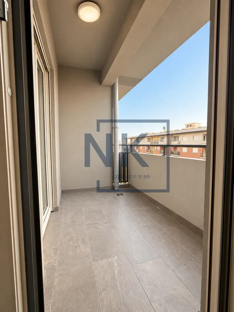 Spacious covered balcony with ceramic floor tiles.