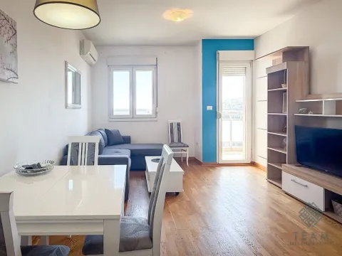 Living room with a dining table, sofa set, and TV unit. - image 3