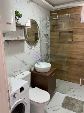 Modernly equipped bathroom with a shower cabin, washbasin and washing machine. - image 5