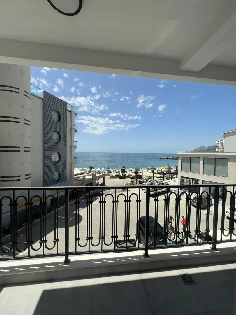 View from the balcony towards the sea and nearby buildings.