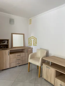 Living room with wooden furniture and an armchair. - image 7