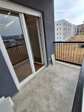 Unfurnished balcony with tiled flooring and a view of surrounding buildings. - image 9