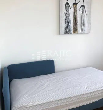 Bedroom with a single bed and a wall painting. - image 6