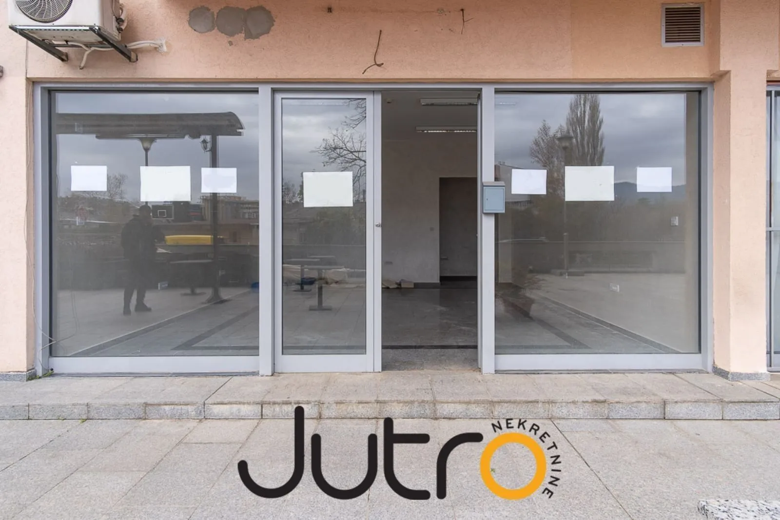 Exterior view of a commercial space with a large glass storefront.