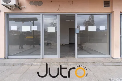 Exterior view of a commercial space with a large glass storefront. - image 2