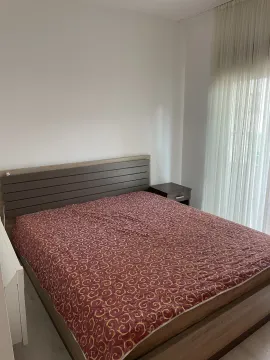 Furnished bedroom with a double bed and a nightstand. - image 4