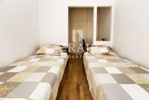 Bedroom with two single beds and a wardrobe. - image 16