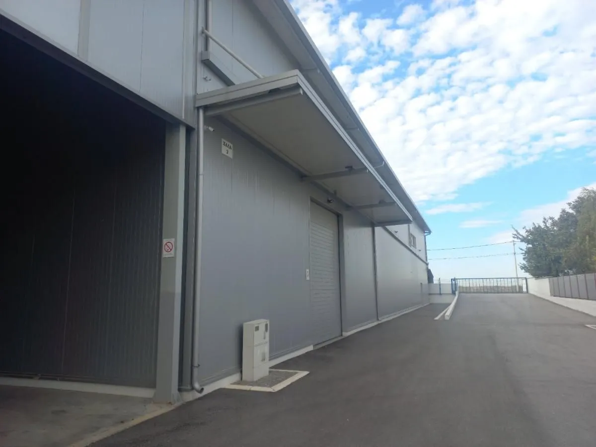 Exterior of an industrial building with a paved driveway.