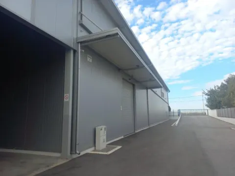 Exterior of an industrial building with a paved driveway. - image 2