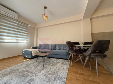 Living room with a sofa, dining table, and chairs. - image 2