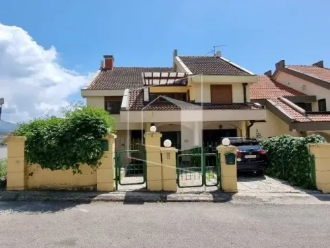 Front view of the house with a courtyard, fence, and a parked car. - image 21