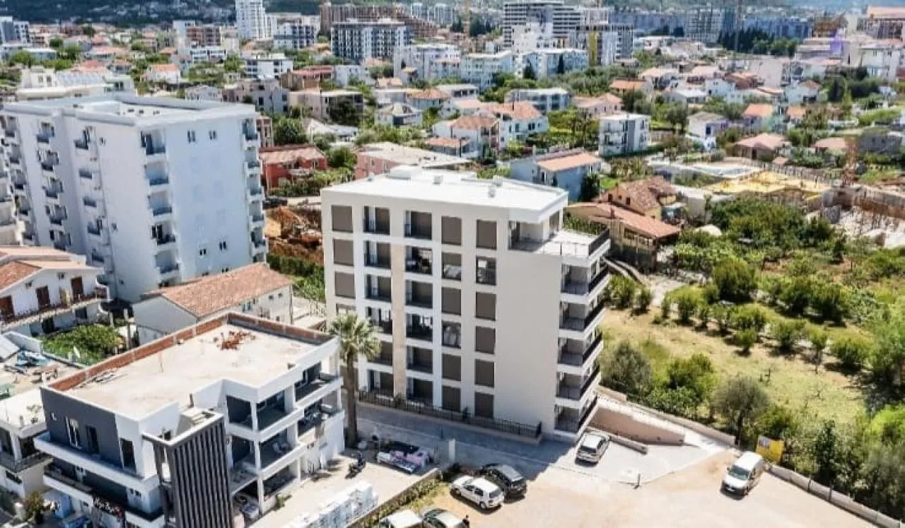 Aerial view of the residential building and the surrounding neighborhood.