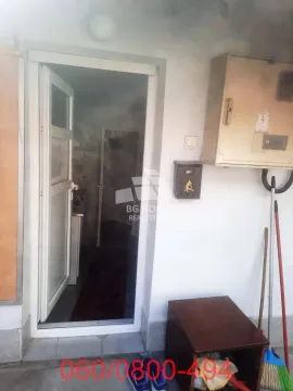 Building entrance with an open door and a junction box on the wall. - image 5