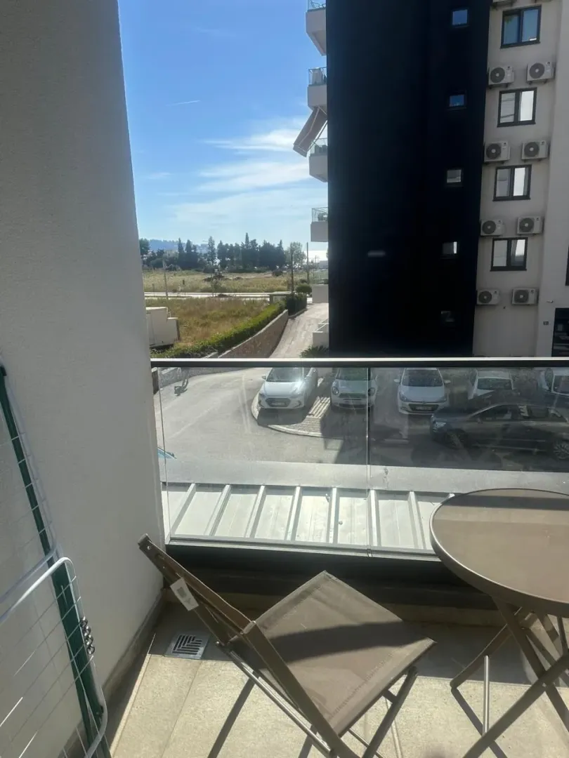 Terrace with a table, chair, and surrounding view.