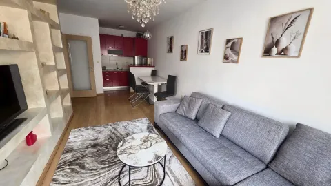 Living room with sofa, coffee table and view of the dining area and kitchen. - image 5