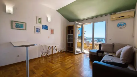 Living room with dining area and access to a terrace with a sea view. - image 4