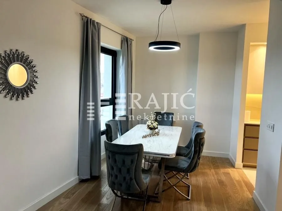 Dining area with a dining table and chairs in a modern apartment.