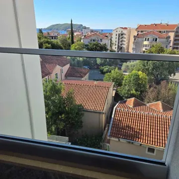 View from the terrace towards surrounding buildings and the sea. - image 9