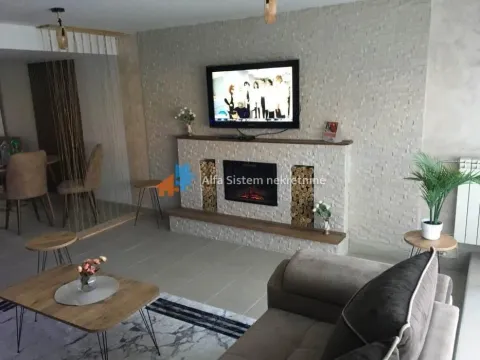 Living room with a fireplace, television, and seating set. - image 3